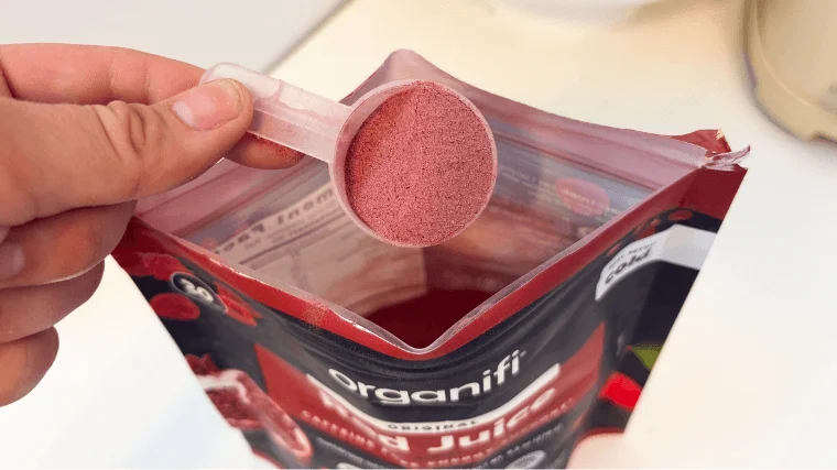 Our tester grabbing a scooped serving of Organifi Red Juice
