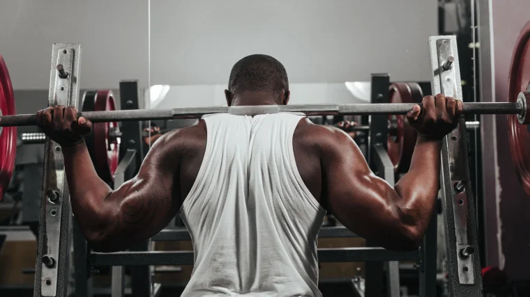 A person doing a back squat.