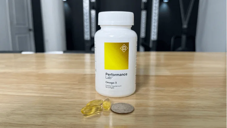 Performance Lab Omega-3 capsules compared to a standard coin