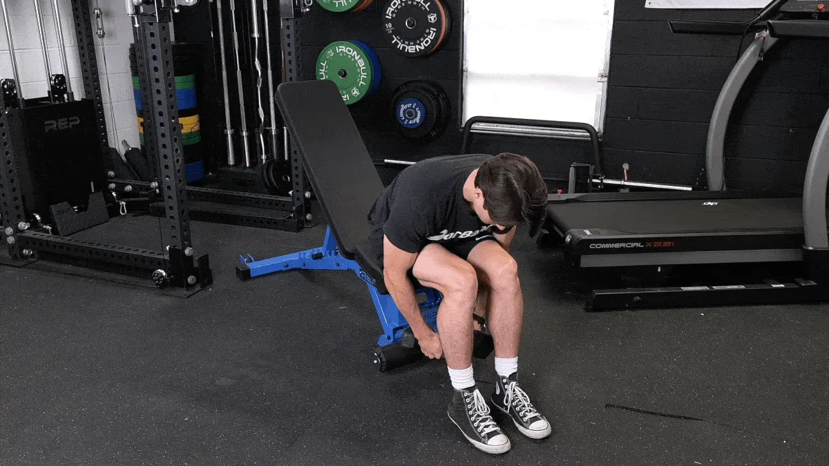 A person demonstrating the seated bent-over reverse flye movement.