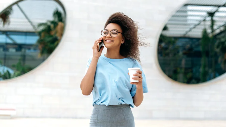 A person talking on the phone while outside.