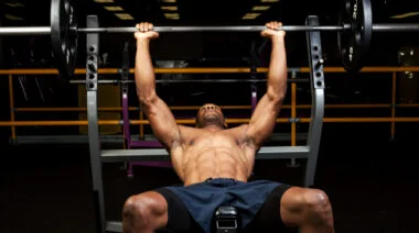 A person prepares to perform an incline barbell bench press.