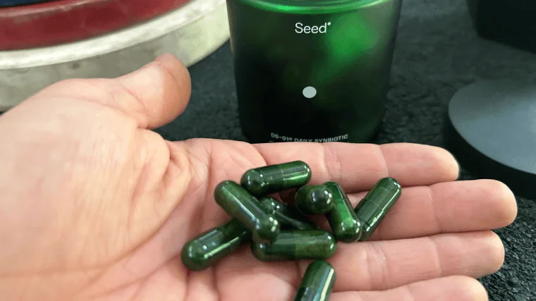 A handful of Seed Daily Synbiotic capsules.