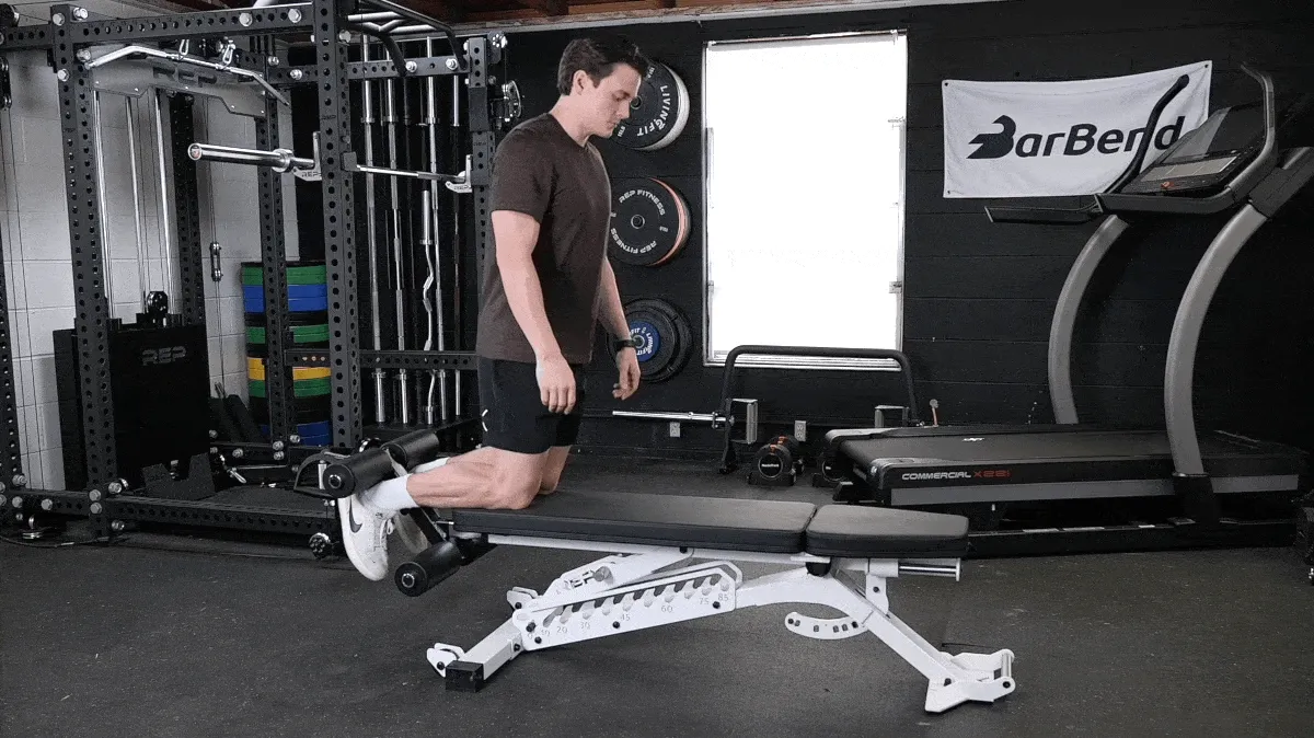 A person doing the Nordic hamdstring curl.