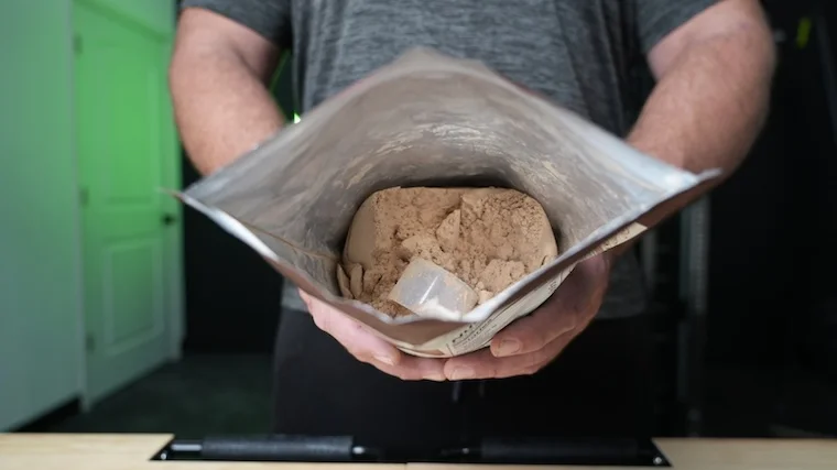 An open container of KOS Organic Plant Protein