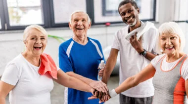 Multicultural laughing senior while putting hands together