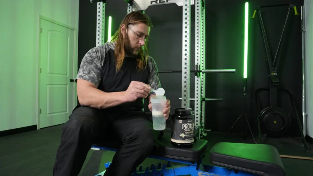 Our tester dumps a scoop of Onnit Whey Protein.