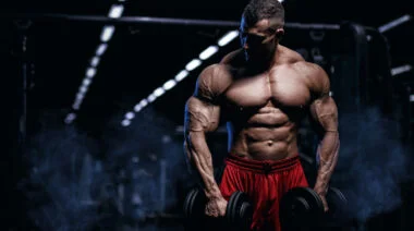 A bodybuilder holding dumbbells.