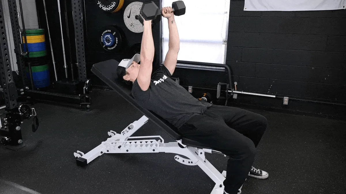 BarBend's Jake Herod performing the incline barbell bench press exercise.