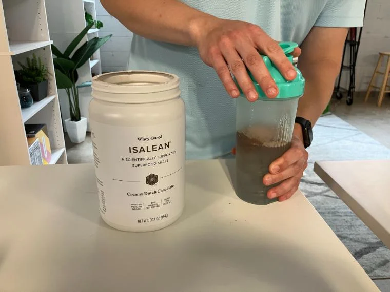 Our tester holding a shaker cup with Isagenix IsaLean Shake.