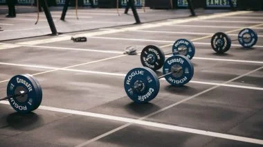 Barbells lay staged for a CrossFit Games competition