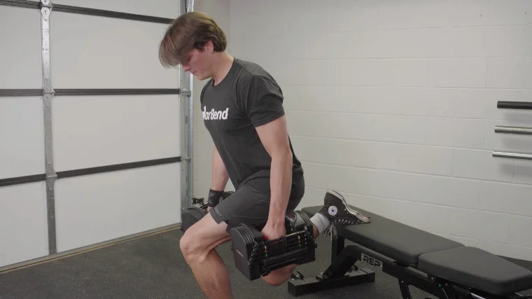 Our tester performing the split squats with the Powerblock Pro 50 Adjustable Dumbbells.