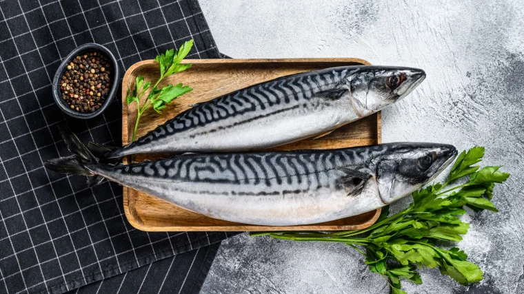 A couple of fish on a tray ready to cook.