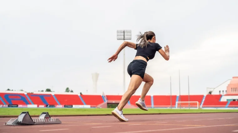 How Many Miles is a 5K: An athlete running on a running track.