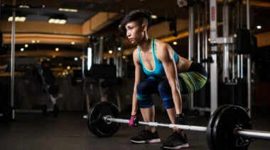A person prepares to perform a deadlift.