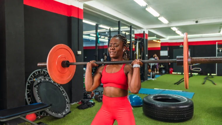 A person prepares to perform a push press.