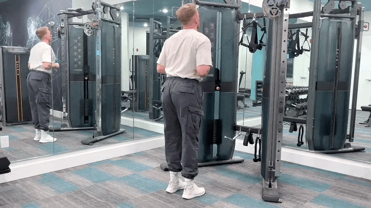 A person performing the cable cross-body triceps extension exercise.