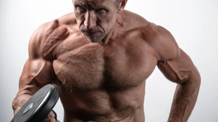Aged bodybuilder performs curl