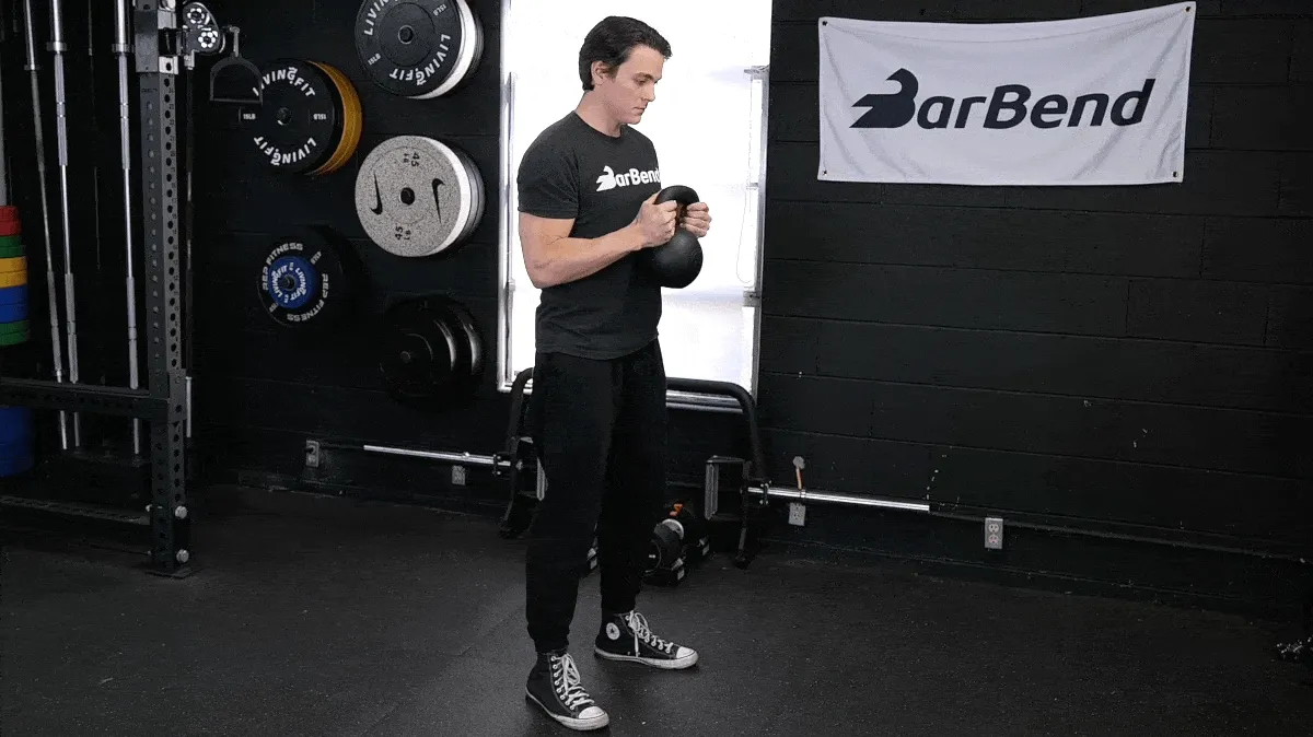 A person performing the goblet squat exercise.