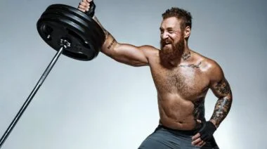 An athlete doing landmine shoulder exercises.