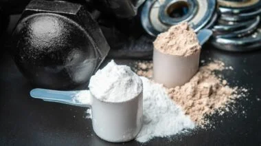 Two scoops full of pre-workout powdered supplement.