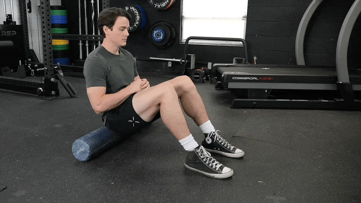 A person doing the thoracic foam rolling movement. 