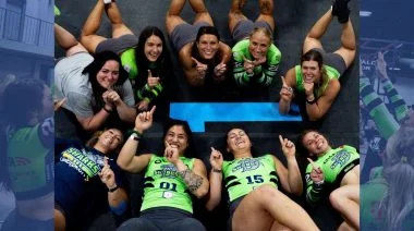 A group of athletes lounging on the mat for a photo op