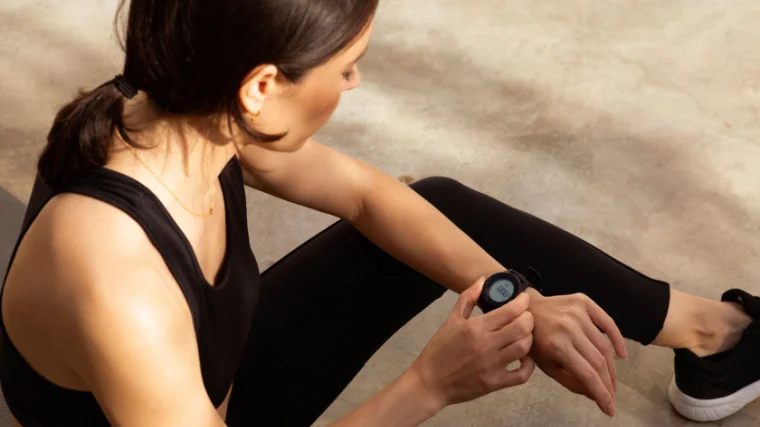 A person checking their pulse rate on their fitness tracker.