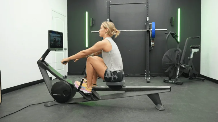 Our tester taking in a trainer-led workout on the Hydrow Wave rowing machine