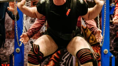 Powerlifter bracing his core during a squat