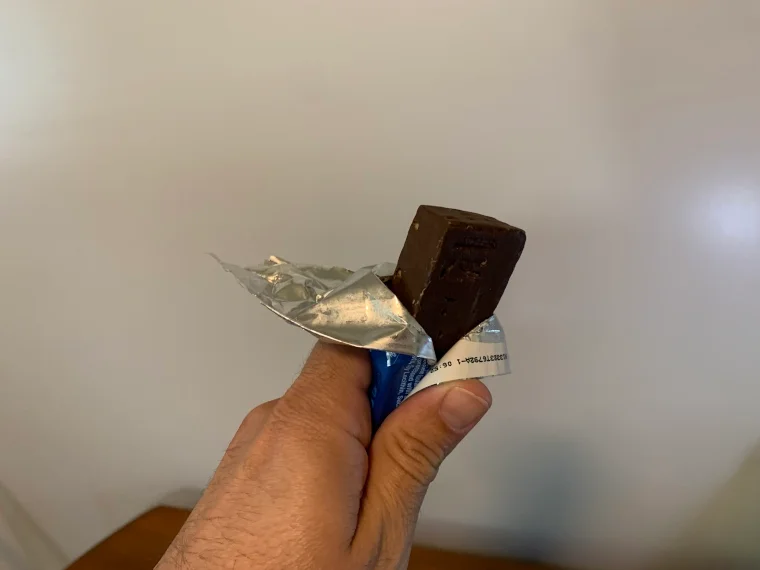 Our tester holds an unwrapped and untouched protein bar from Pure Protein.