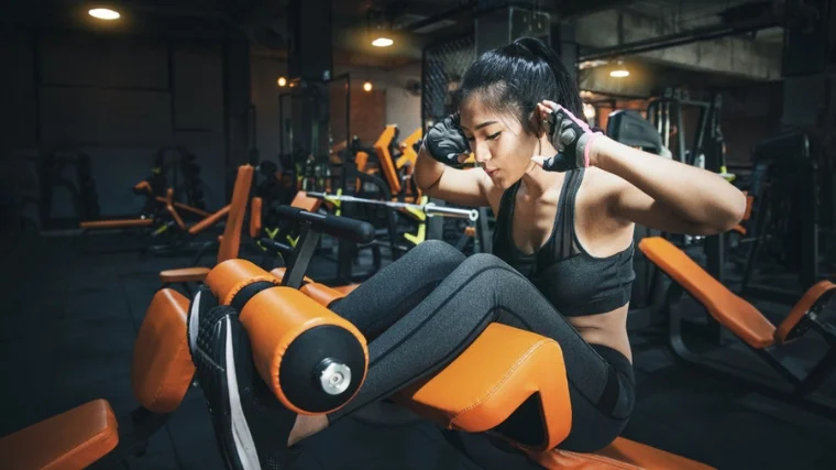 A person doing inclined sit ups.