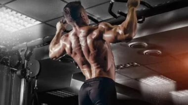 A muscular person doing a pull-up.