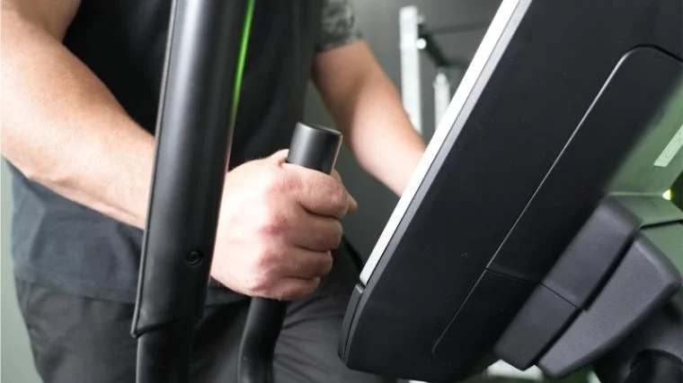 Our tester holding the handles on the NordicTrack AirGlide 14i.