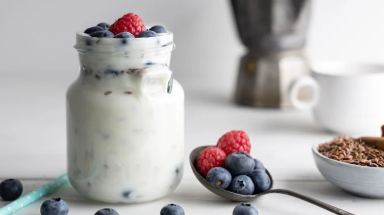 Yogurt in a mason jar with berries and granola