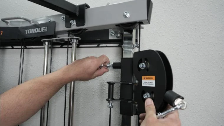 Our tester adjusting the pulley height on the Torque Fitness Anker 7.