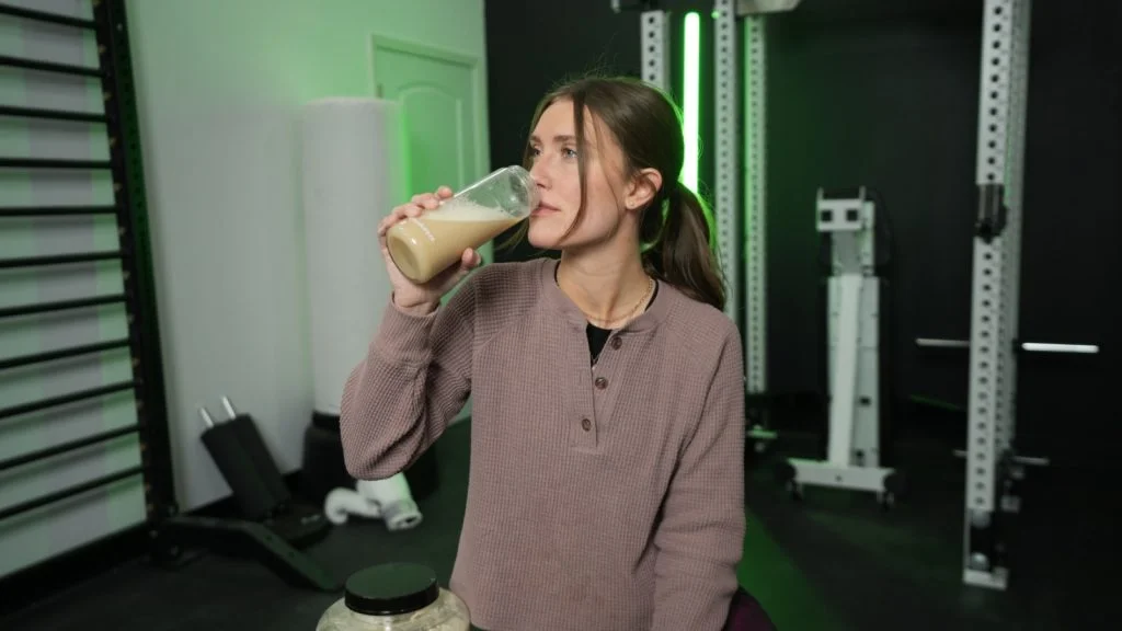 Woman drinking a serving of Naked Pea Protein Isolate