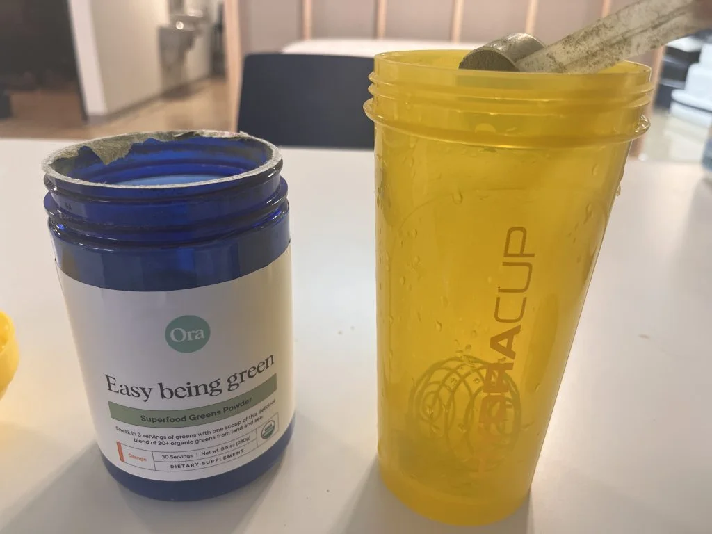 ora-organic-greens-after-mixing Ora Organic Greens beside our tester's shaker cup.