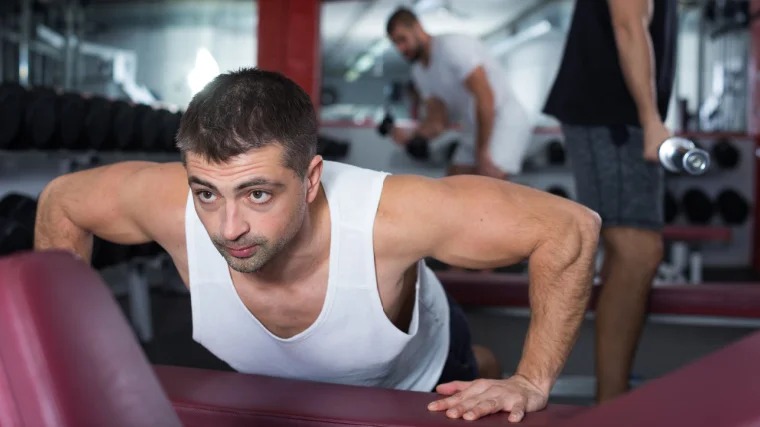 An athlete doing incline push-ups.