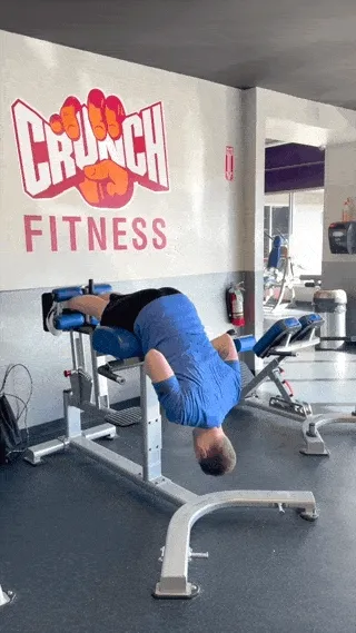 A person performing  the glute ham raise exercise.