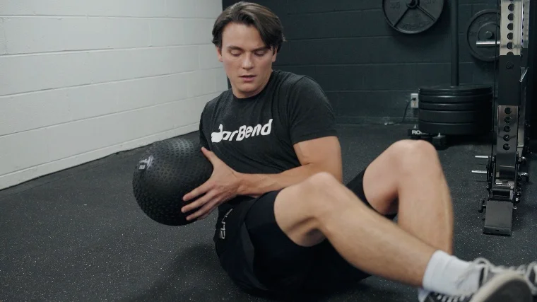Jake Doing Russian Twists with a Living.Fit Slam Ball