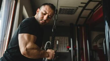 Muscular person working out in the gym.