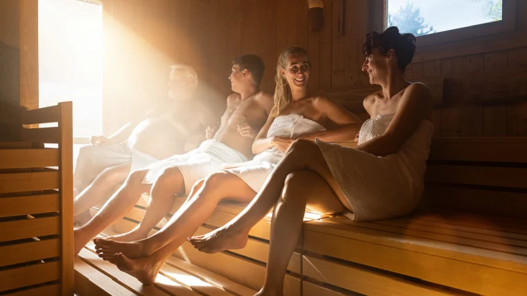 A group of fit individuals relaxing in the sauna.