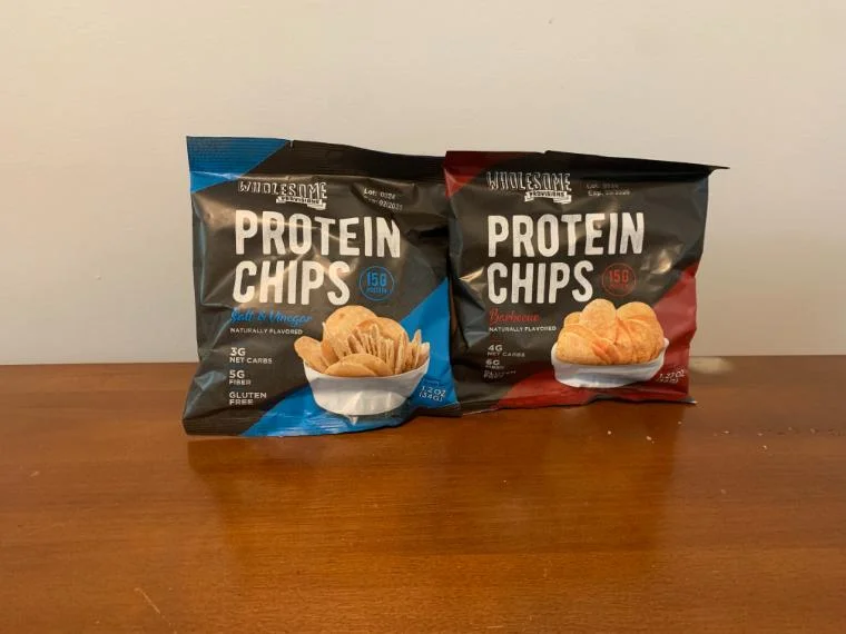 Two bags of Wholesome Provisions Protein Chips sitting on our tester's kitchen table.