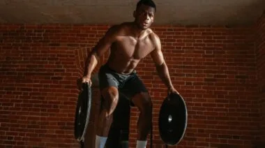 A person working out with weight plates.