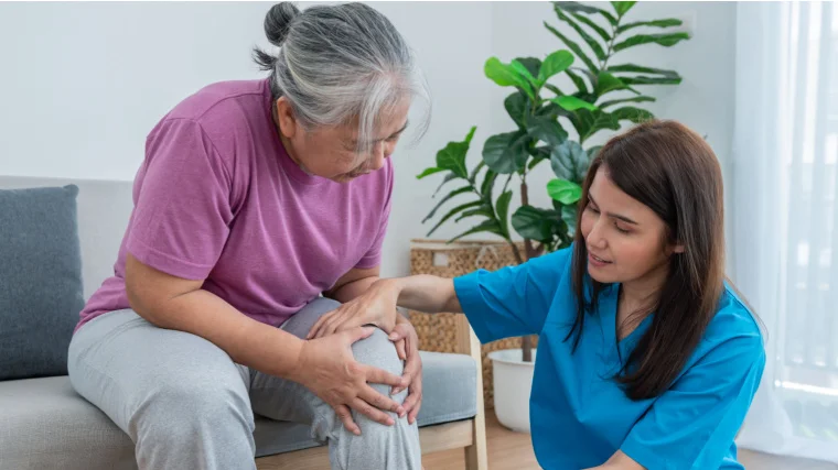 A physical therapist, doing leg physiotherapyy for a person with nerve pain on the leg.