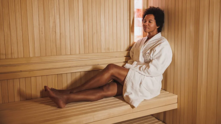 A barefoot person resting in the sauna.