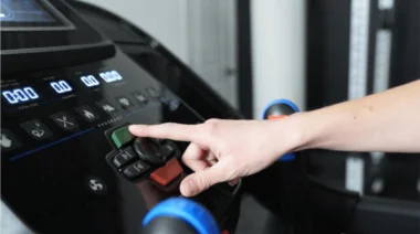 This photo shows someone pressing buttons on a Horizon 7.0 AT Treadmill console.