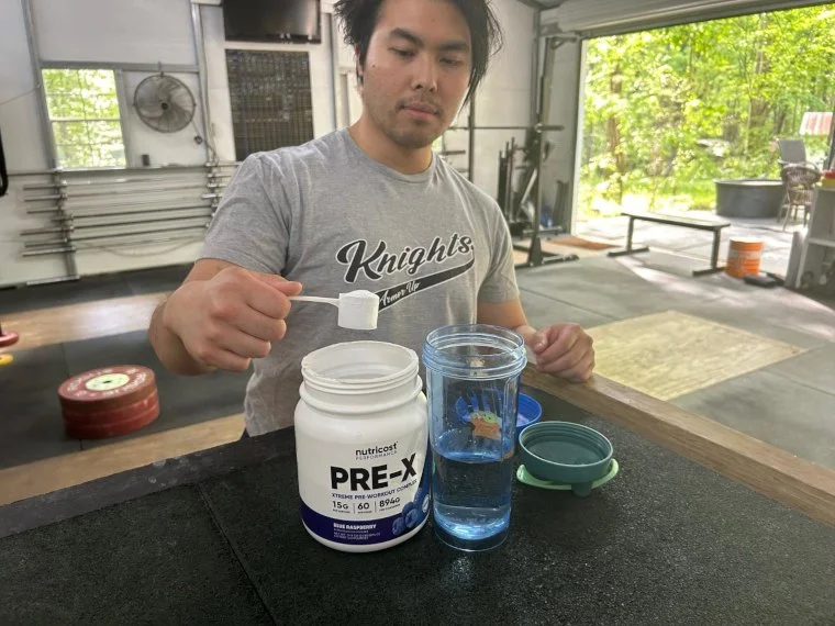 Our tester scooping up some Nutricost Pre-Workout.