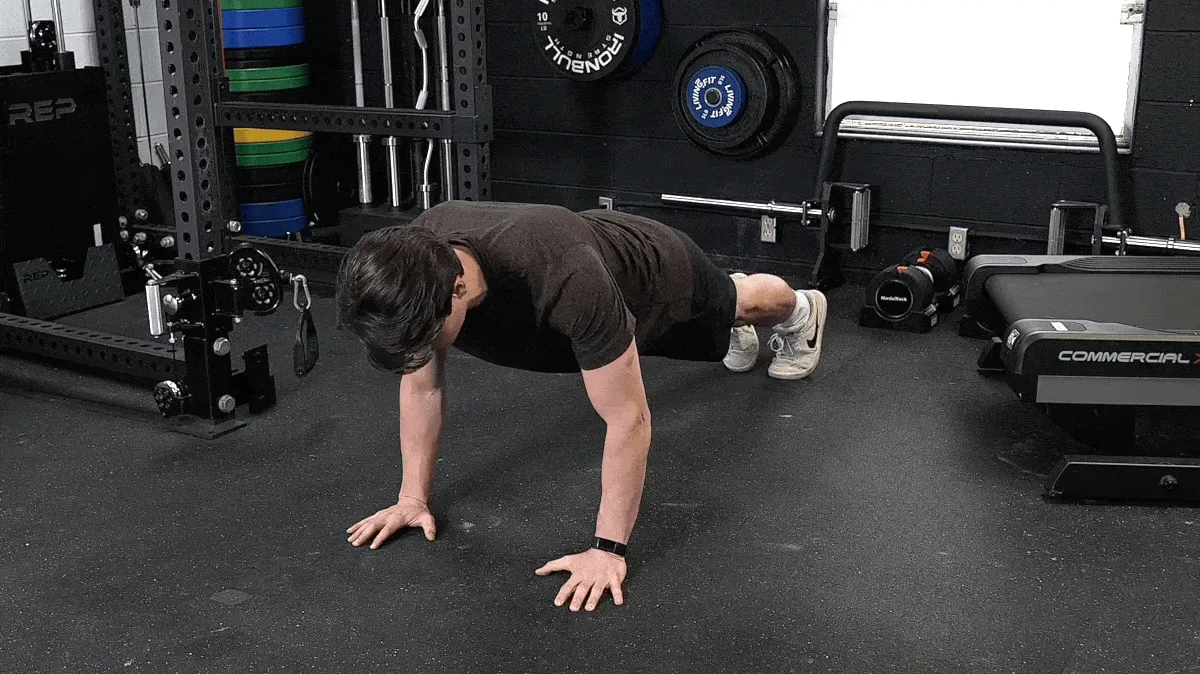 A person doing the spider plank exercise.